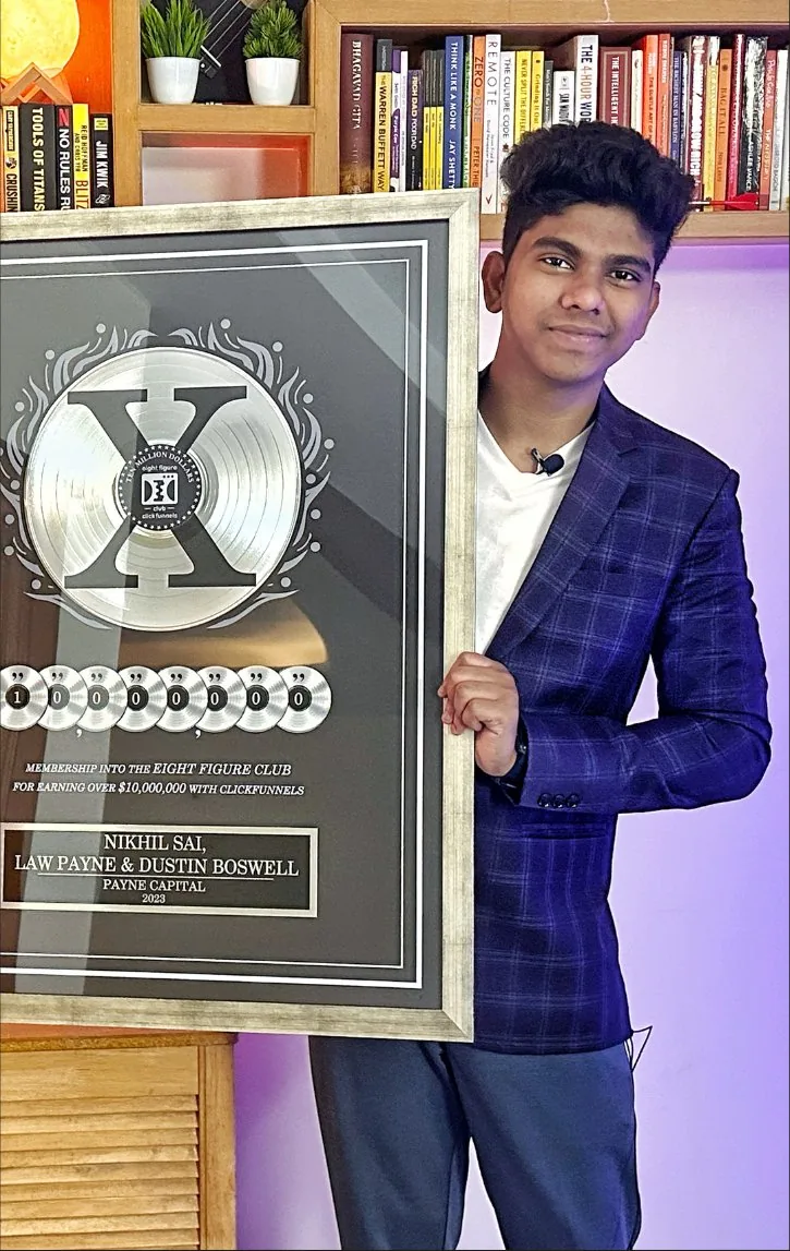 Nikhil Sai holding the ClickFunnels Eight Figure Club plaque